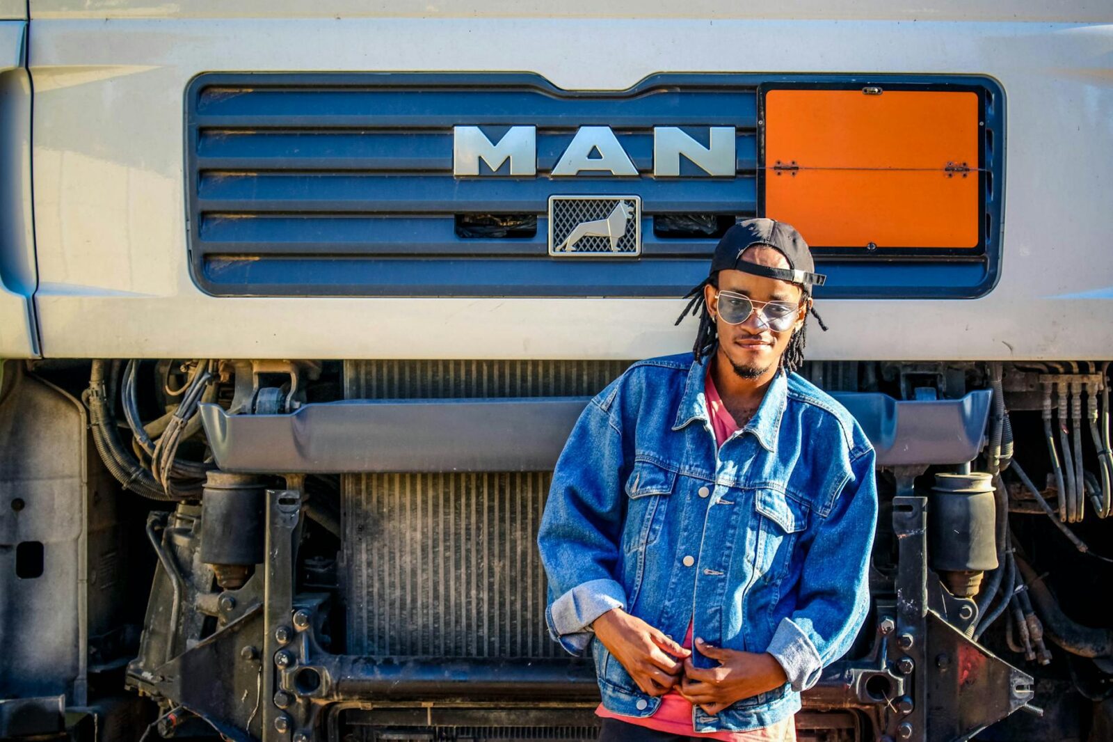 man standing in front of truck The Pros And Cons Of Becoming A Truck Driver