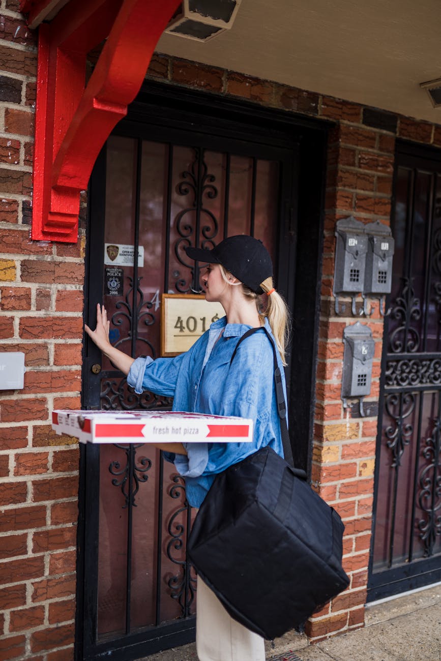 delivery woman at the door Overwhelmed By Debt? Here's How to Get Through It