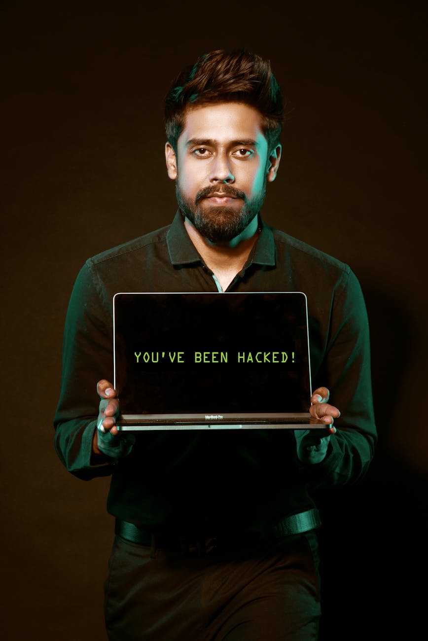 man holding laptop computer with both hands Why Email Security Still Gets Overlooked (And What To Fix Today)