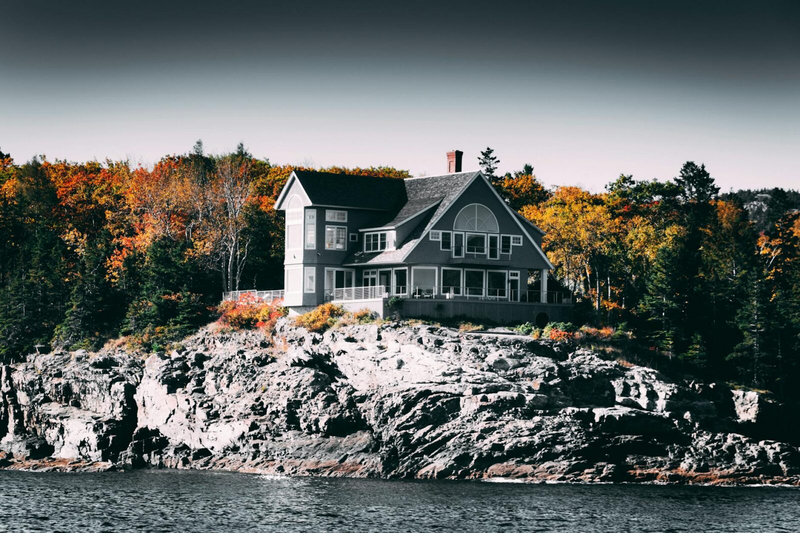 gray and white house beside body of water What Makes a Market “Elite”: High-End Vacation Rental Investment Hubs