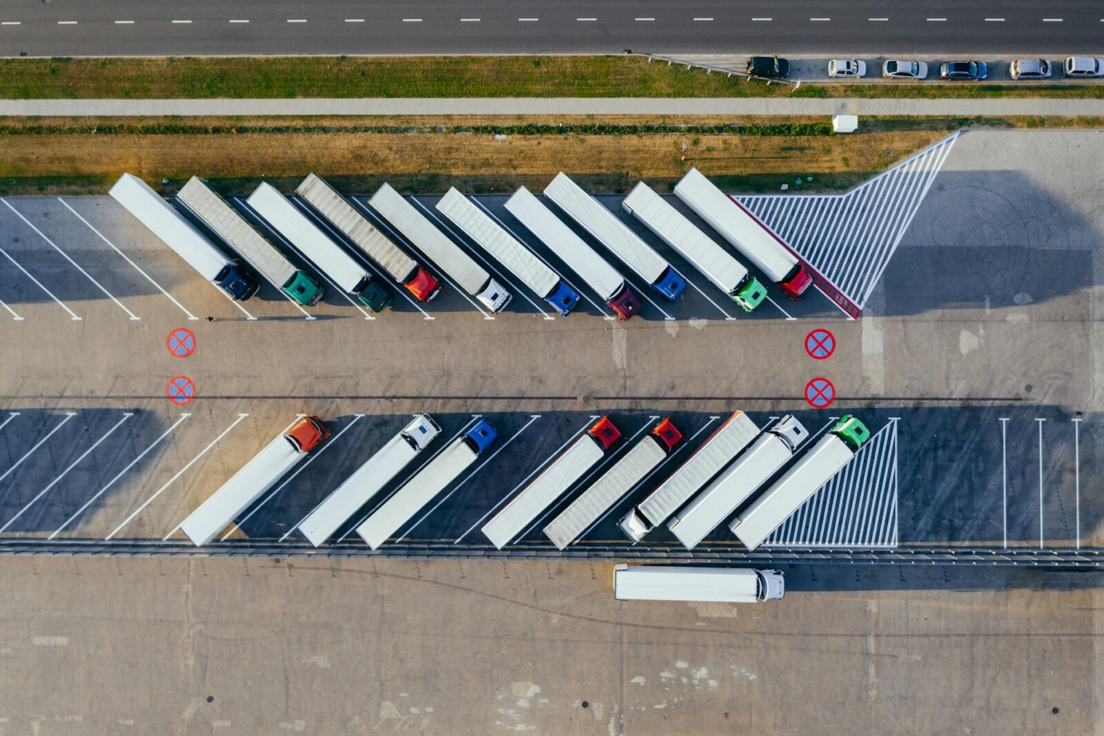 aerial photography of trucks parked The Pros And Cons Of Becoming A Truck Driver
