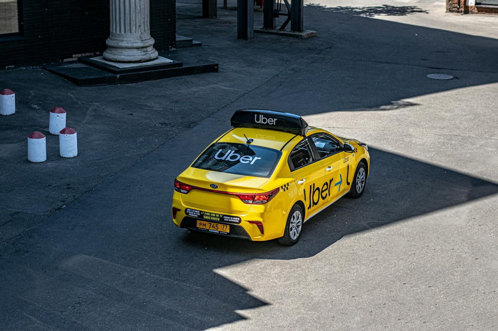 yellow uber taxi on urban street The Pros and Cons of Rideshare Services