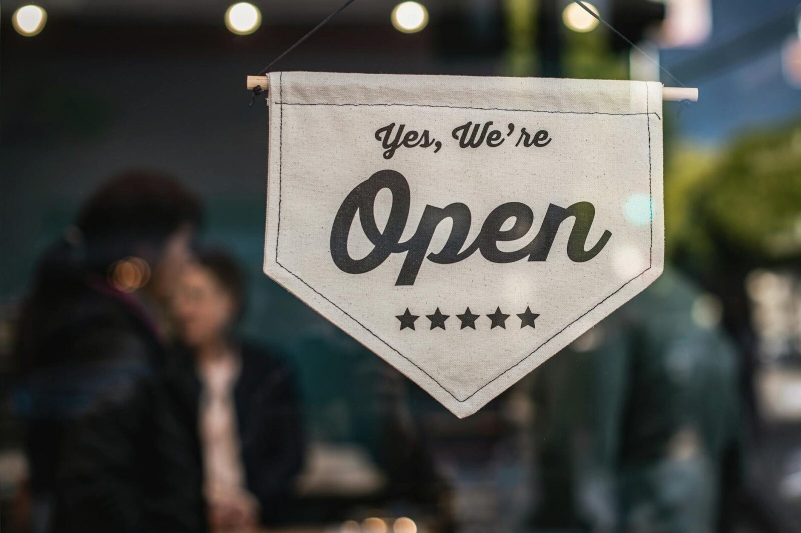 shallow focus photo of white open sigange Avoid These Legal Compliance Dangers When Starting Your Business