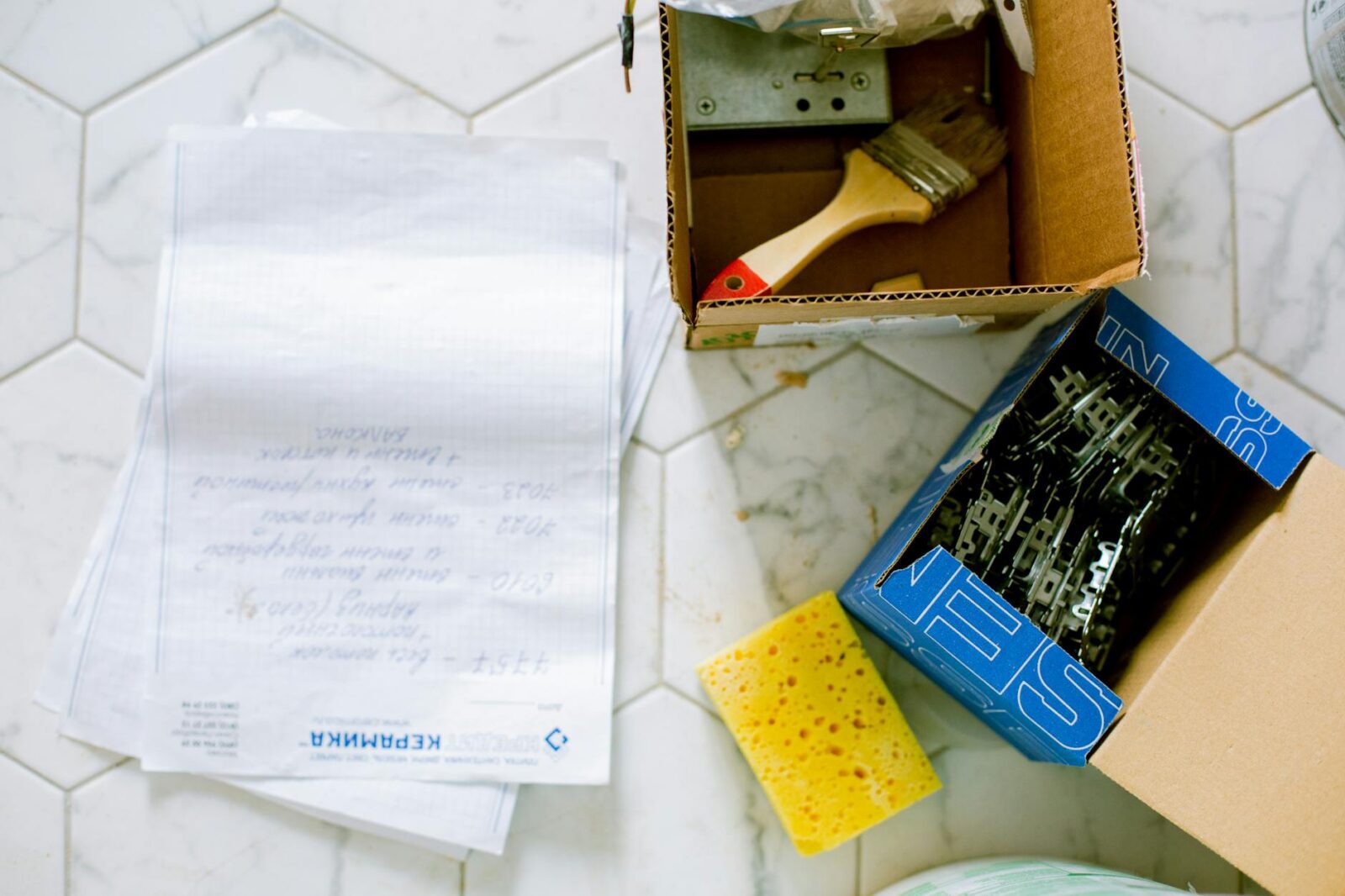 papers sponge and boxes on the floor 5 Practical Tips to Make Home Renovations Easier (and Less Stressful)