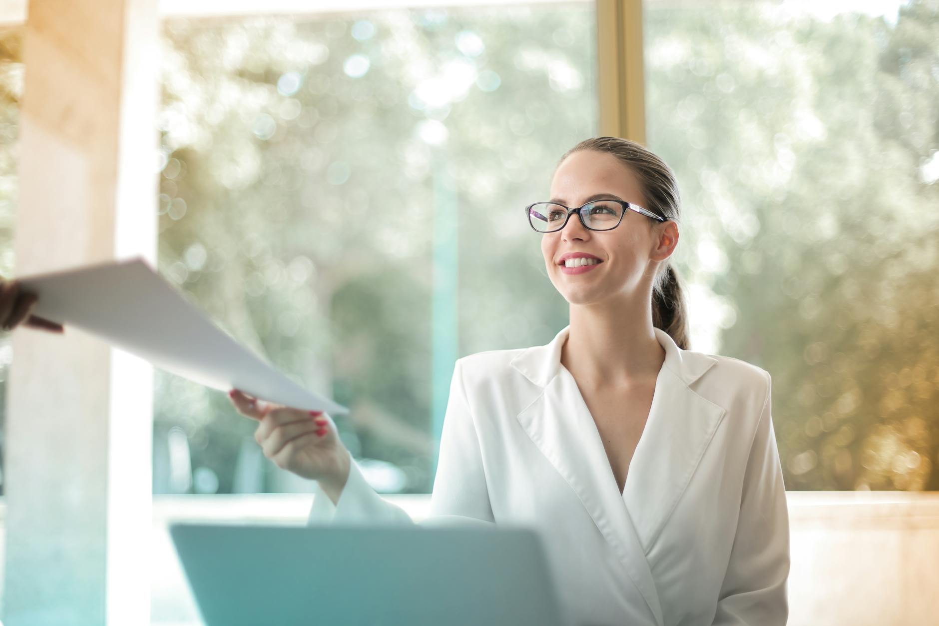 positive businesswoman doing paperwork in office The Unexpected Skills That Can Increase Your Career Confidence