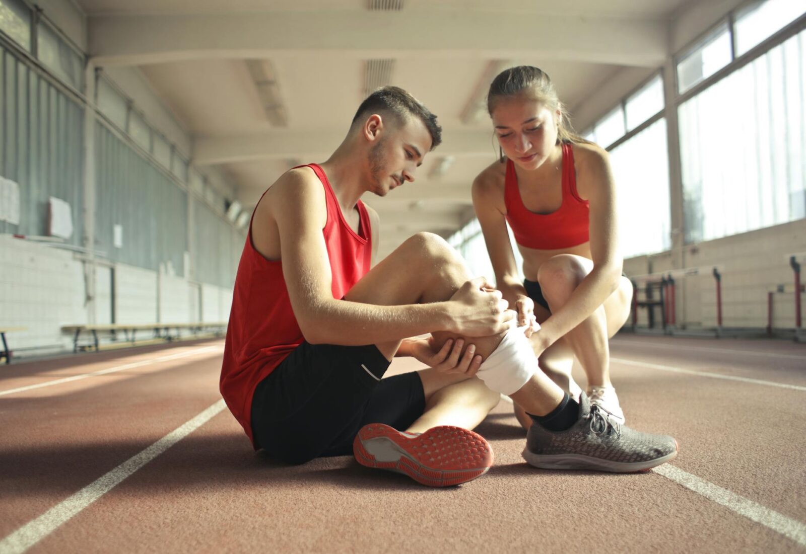 woman wrapping man s leg with bandage Fracture vs Sprain–Do You Have Broken A Bone?