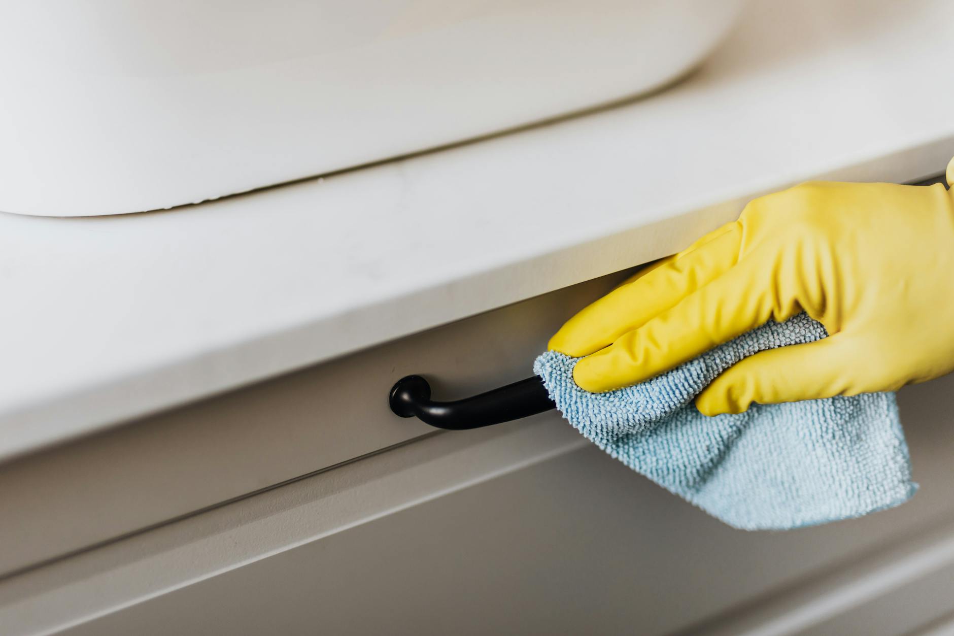 crop housekeeper cleaning handle with rag Why You Should Never Leave Crumbs On Your Kitchen Counter Overnight