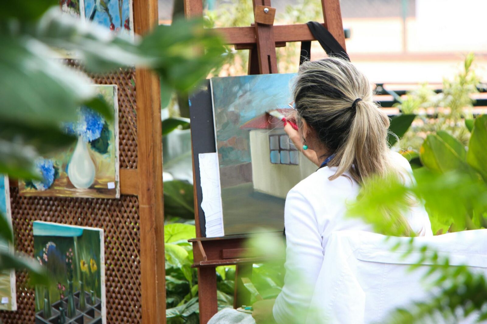 woman painting outside garden How To Rediscover Joy In Your Life