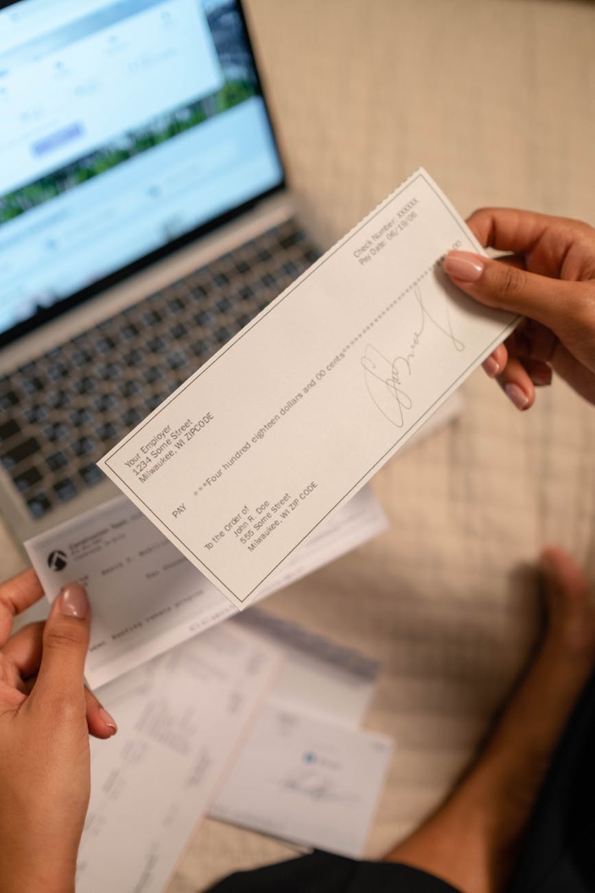 6 Practical Ways of Handling Short-Term Expenses 11 a person s hand holding a cheque 6 Practical Ways of Handling Short-Term Expenses