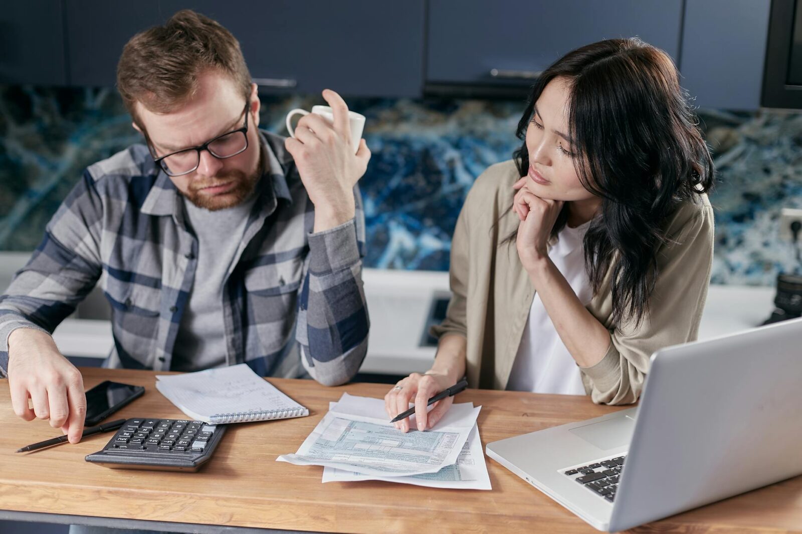 couple people coffee laptop Overwhelmed By Debt? Here's How to Get Through It