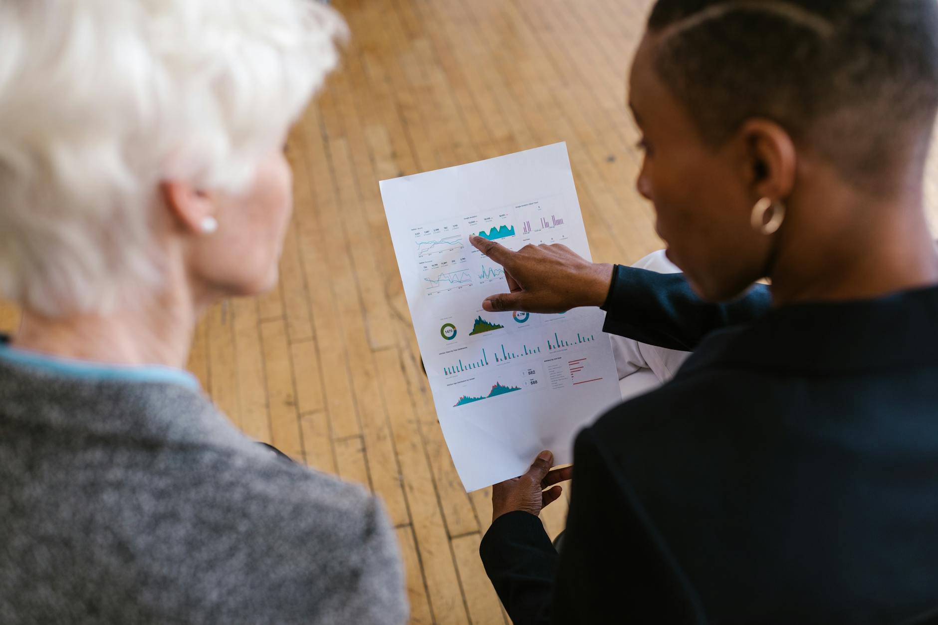 woman pointing finger on a white paper with graphs 7 Foolproof Strategies to Tackle Your Financial Stress