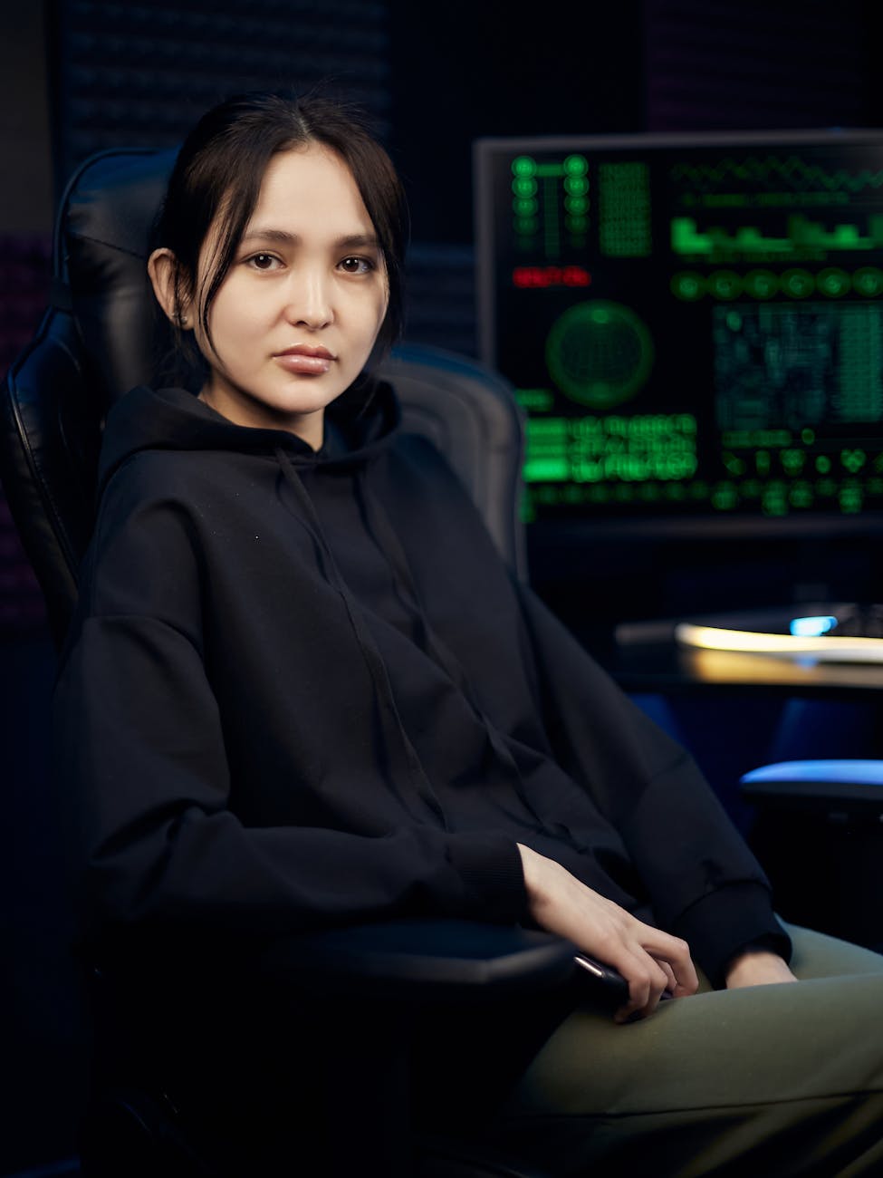 woman in black hoodie sitting near a computer screen 5+ Top Data Centers Supporting Houston’s Small Business Growth