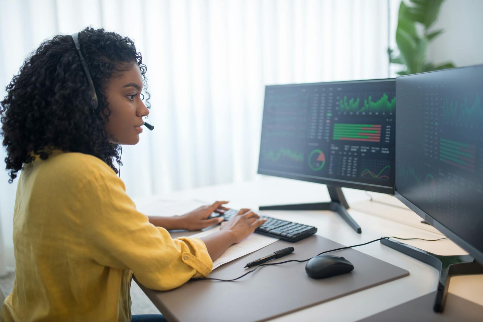 woman in yellow long sleeve shirt looking at computer data Avoid These Legal Compliance Dangers When Starting Your Business