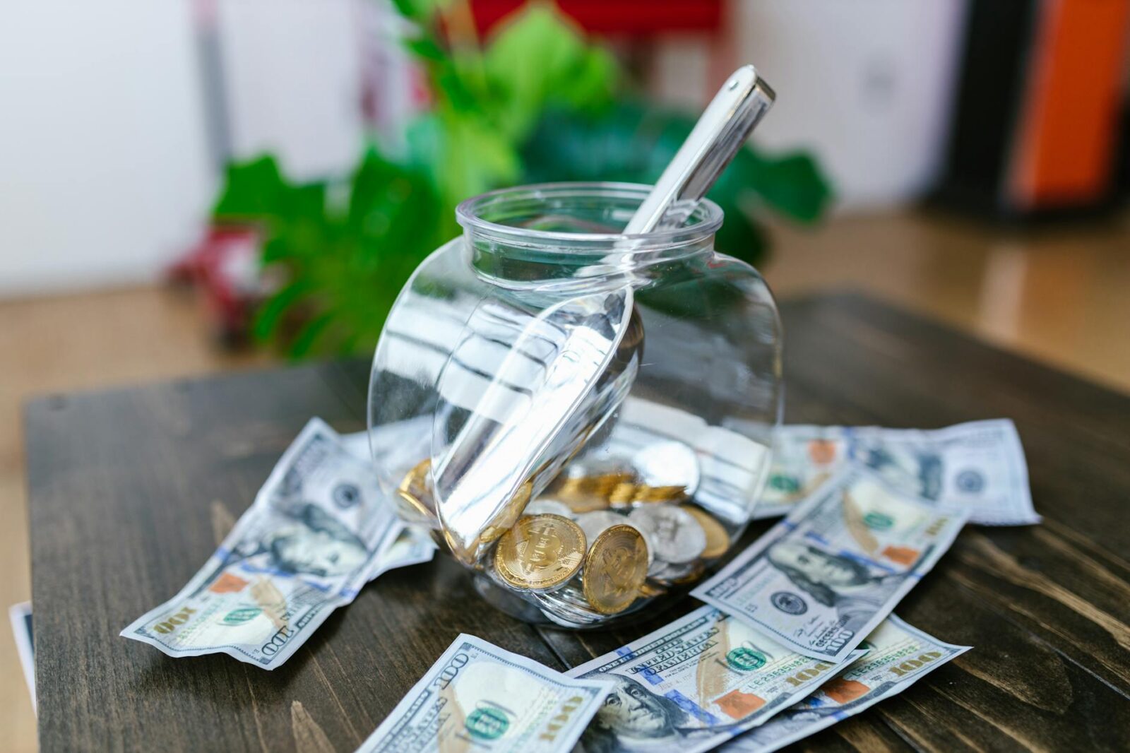 glass container with stainless scooper surrounded with paper bills The Importance of a Small Business Emergency Fund