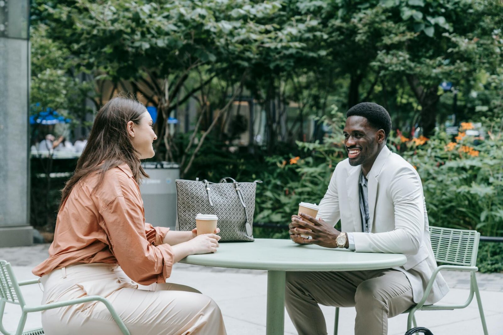 two people talking at a cafe table Small is Big: The Best Small Wins to Boost Your Career Earnings Today