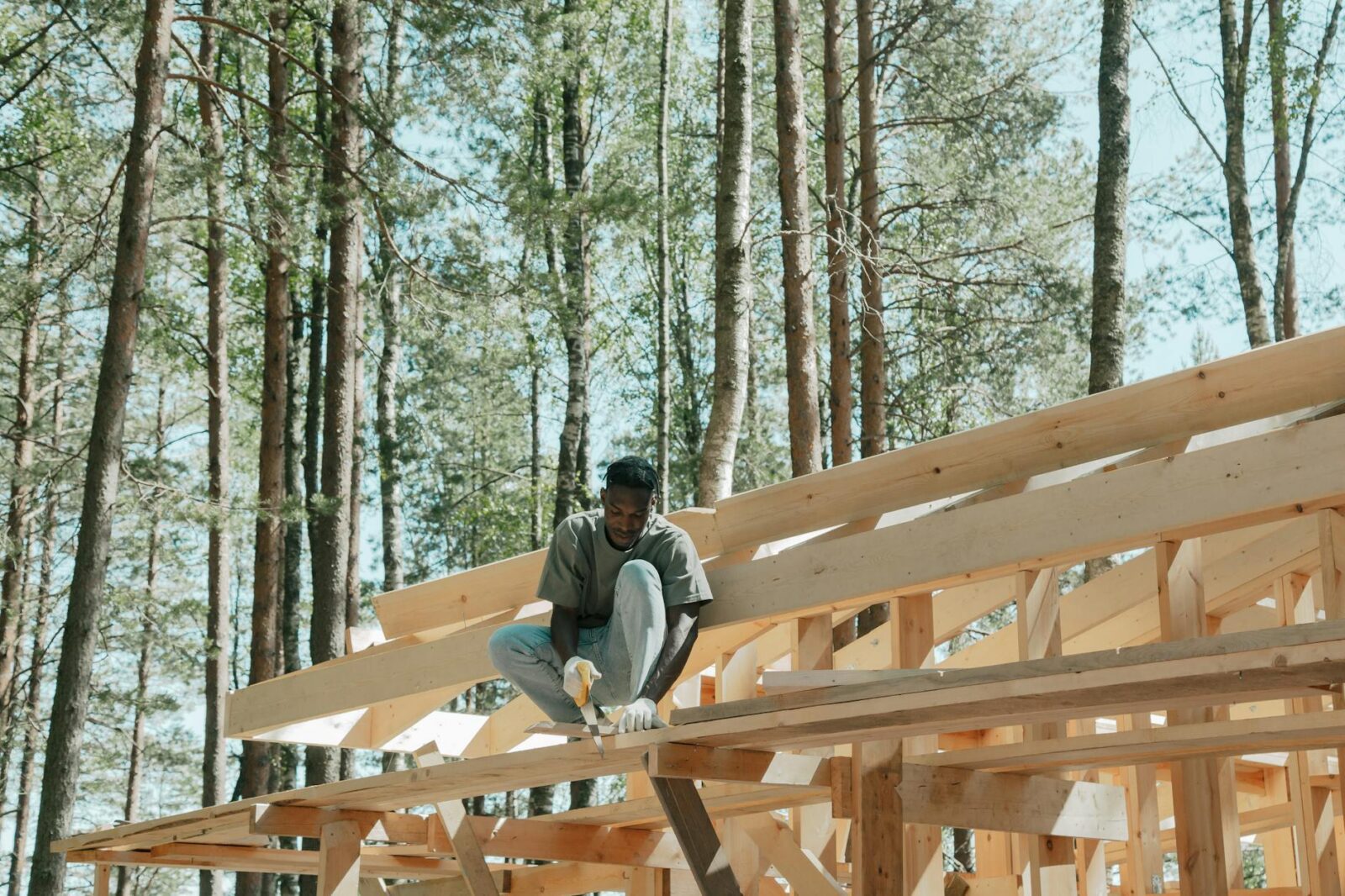 man using hand saw 5 Practical Tips to Make Home Renovations Easier (and Less Stressful)