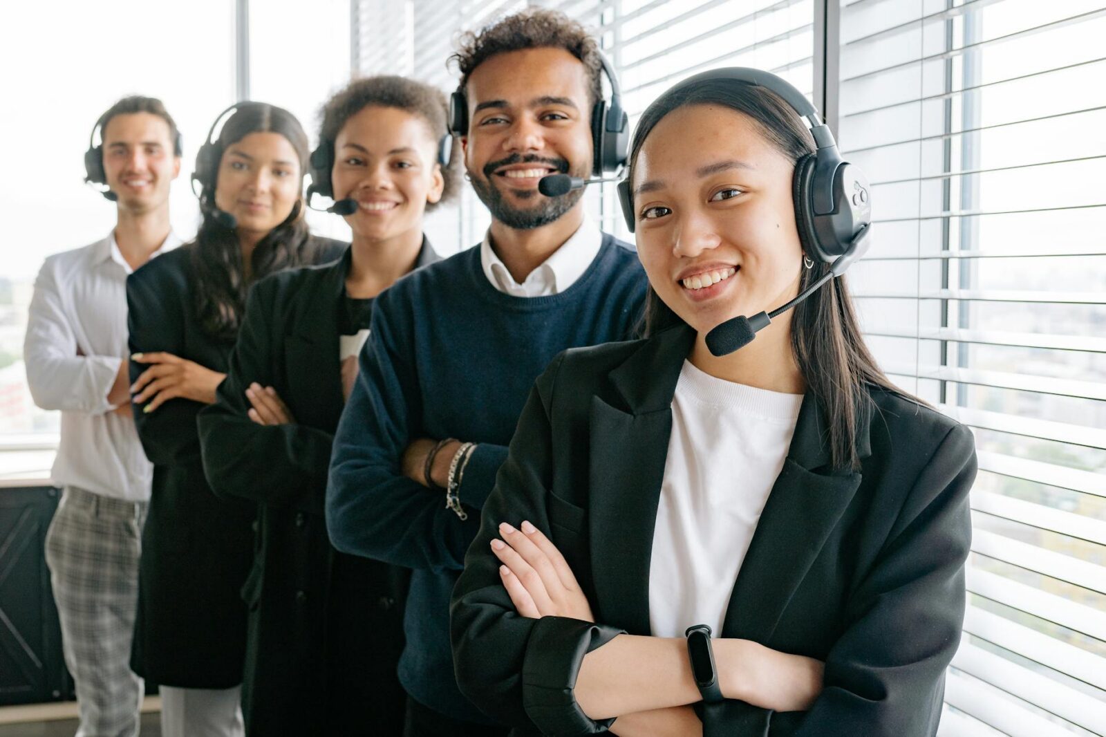 happy call center agents looking at camera 3 Essential Tips to Run a Successful Business & Make a Profit