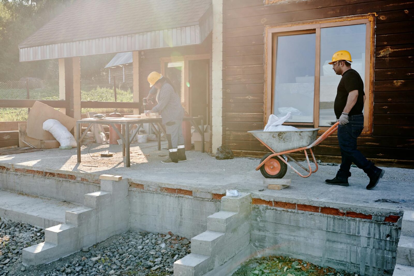 man in black shirt holding gray and orange wheelbarrow 5 Practical Tips to Make Home Renovations Easier (and Less Stressful)
