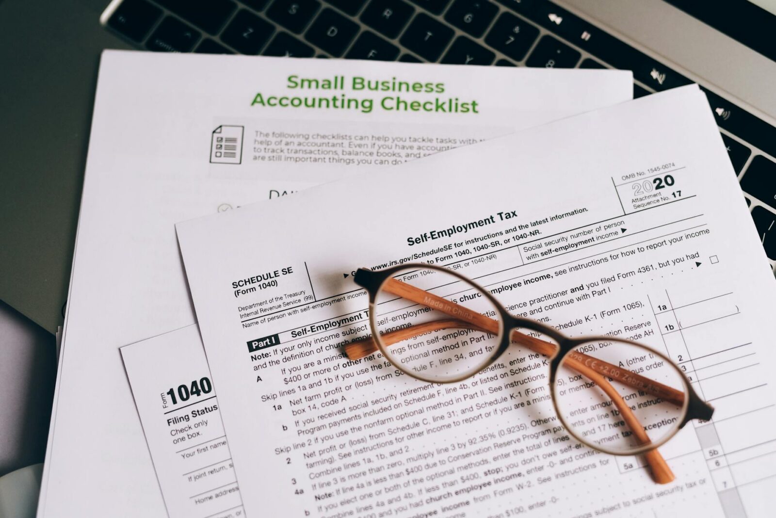 an eyeglasses on top of the documents The Importance of a Small Business Emergency Fund