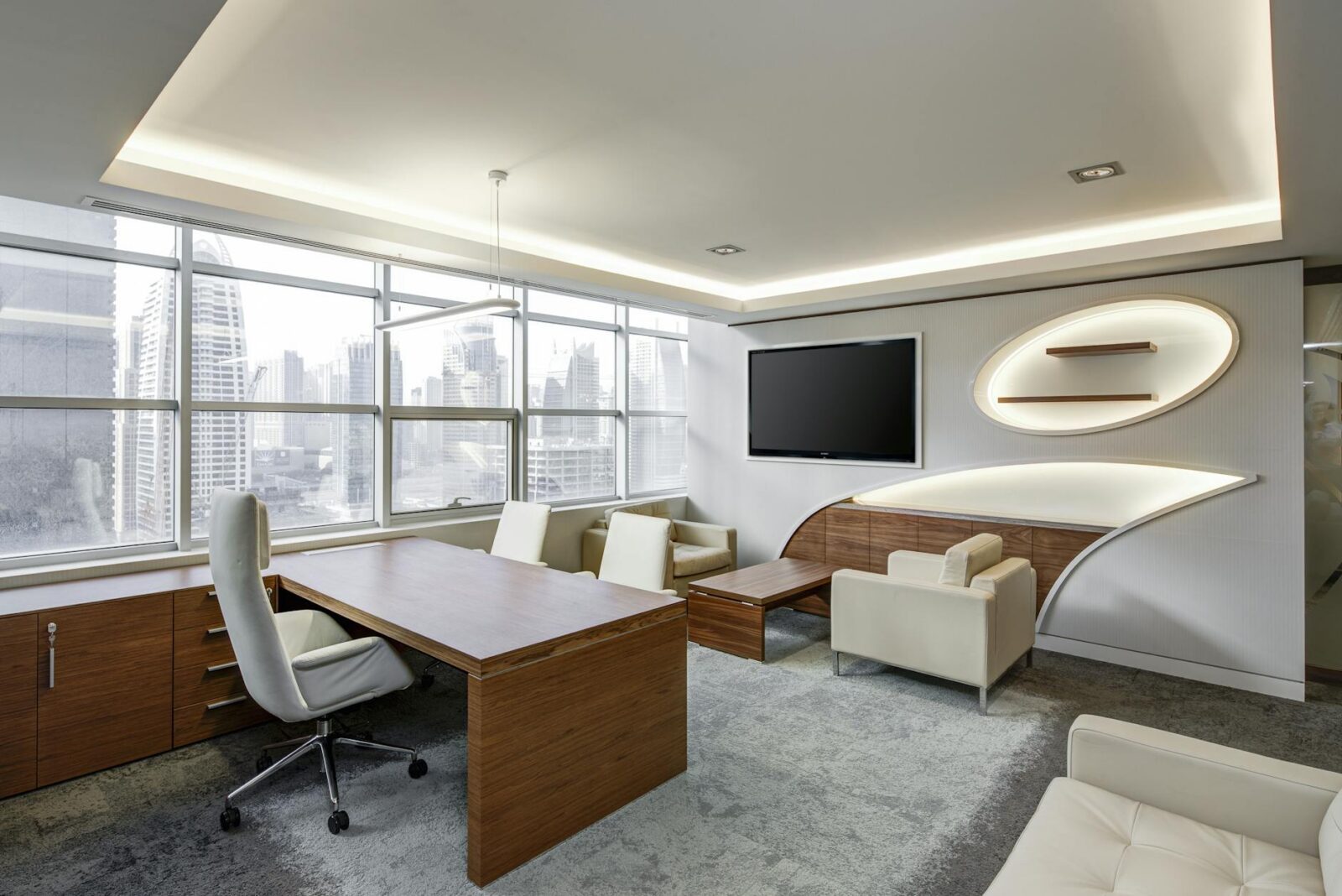 gray office rolling chair near brown wooden desk in front of flat screen tv on white painted wall How to Move Offices Successfully: A Step-by-Step Business Relocation Guide