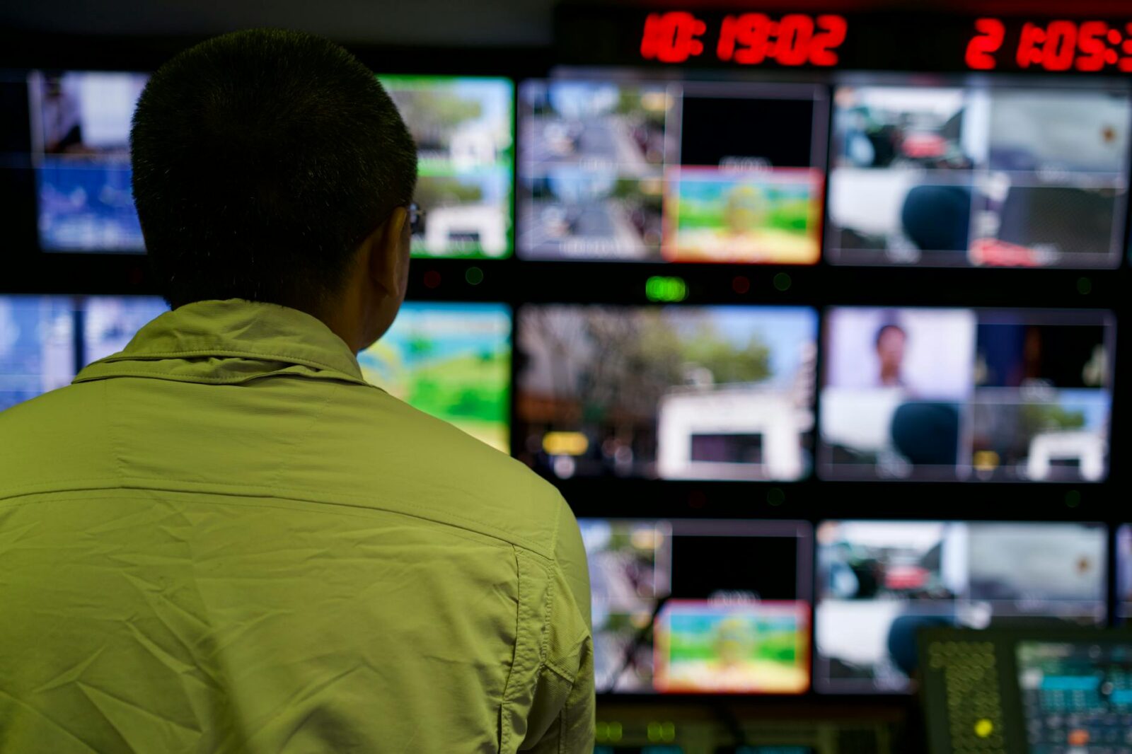 a man looking at multiple monitors The Business Owner's Guide to Video Surveillance & VMS for Company Security