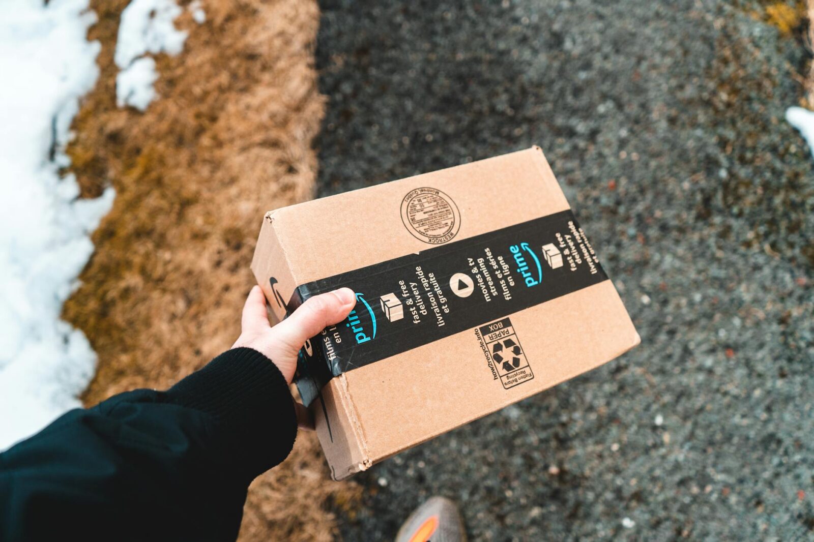 package from amazon prime carried by the delivery man What Top Amazon Sellers Do Differently to Dominate the Marketplace