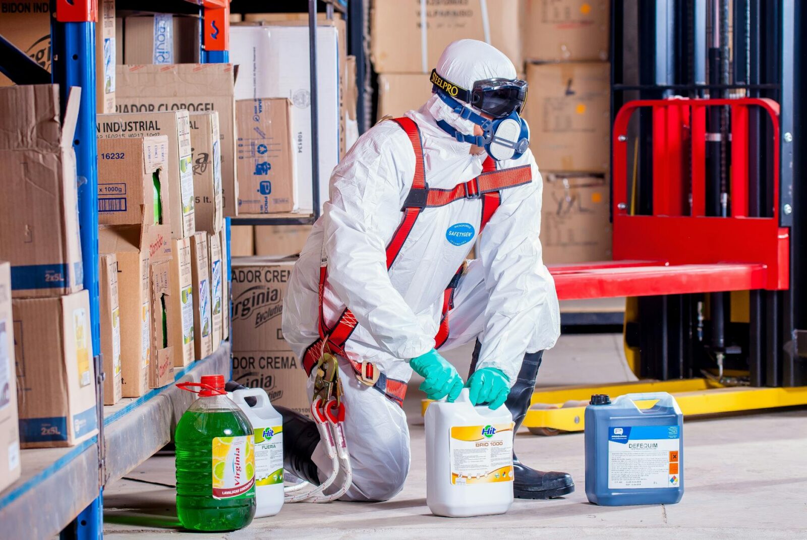 person wearing white suit holding white container The Role of Workplace Safety in Driving Business Success