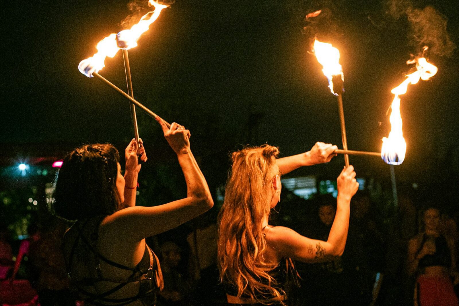 women with flames in the dark