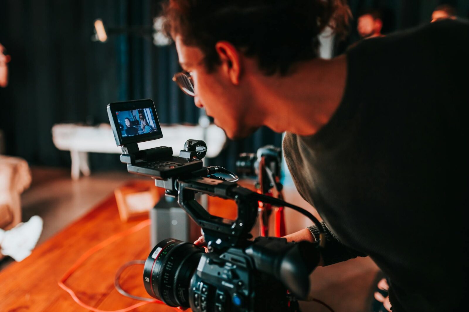 photo of a man holding video camera How Business Communication Technology Is Revolutionizing the Way We Work