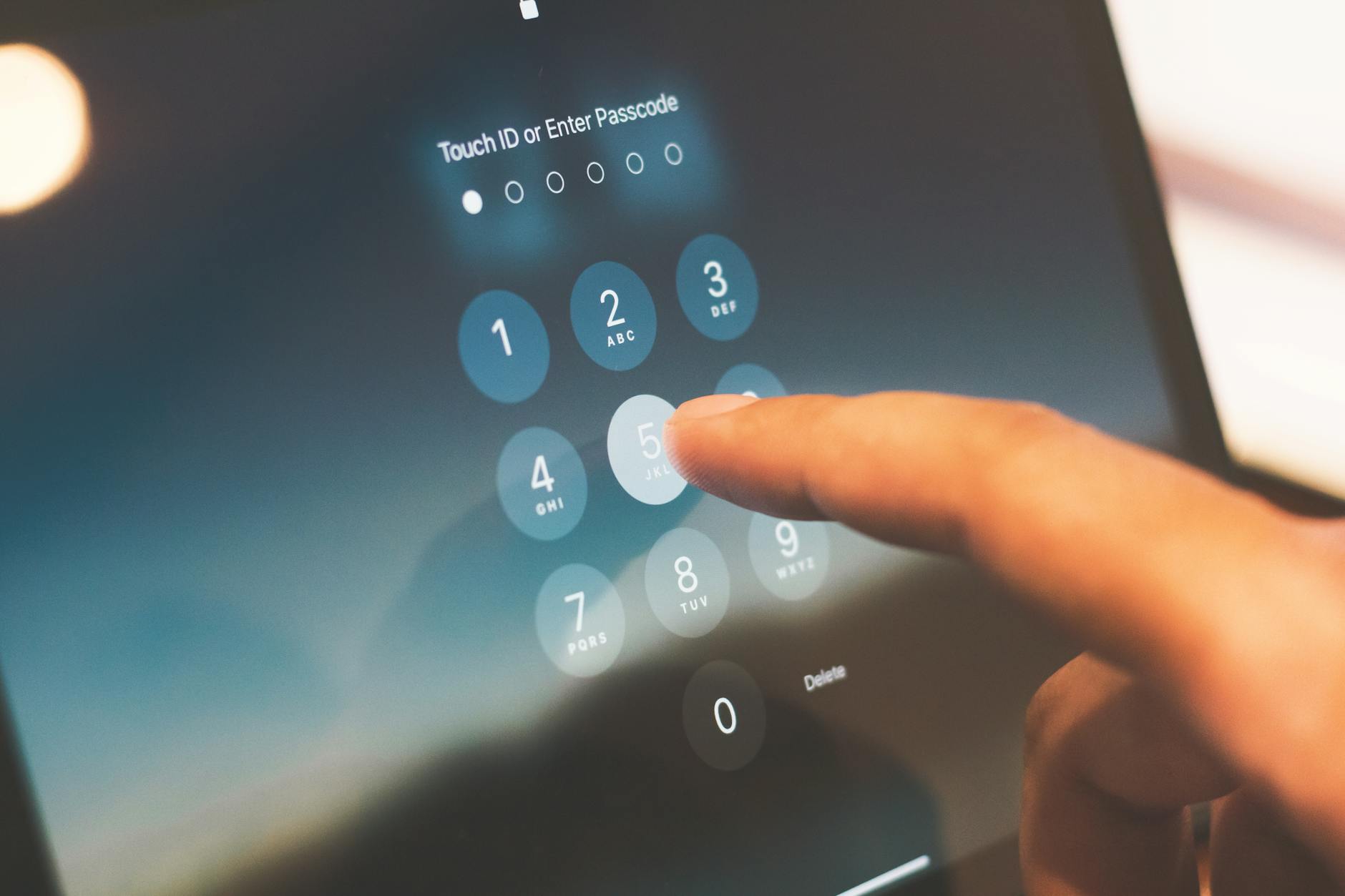 a person s finger is touching a tablet screen The Evolution Of Passwords: From Ancient Codes to Digital Security