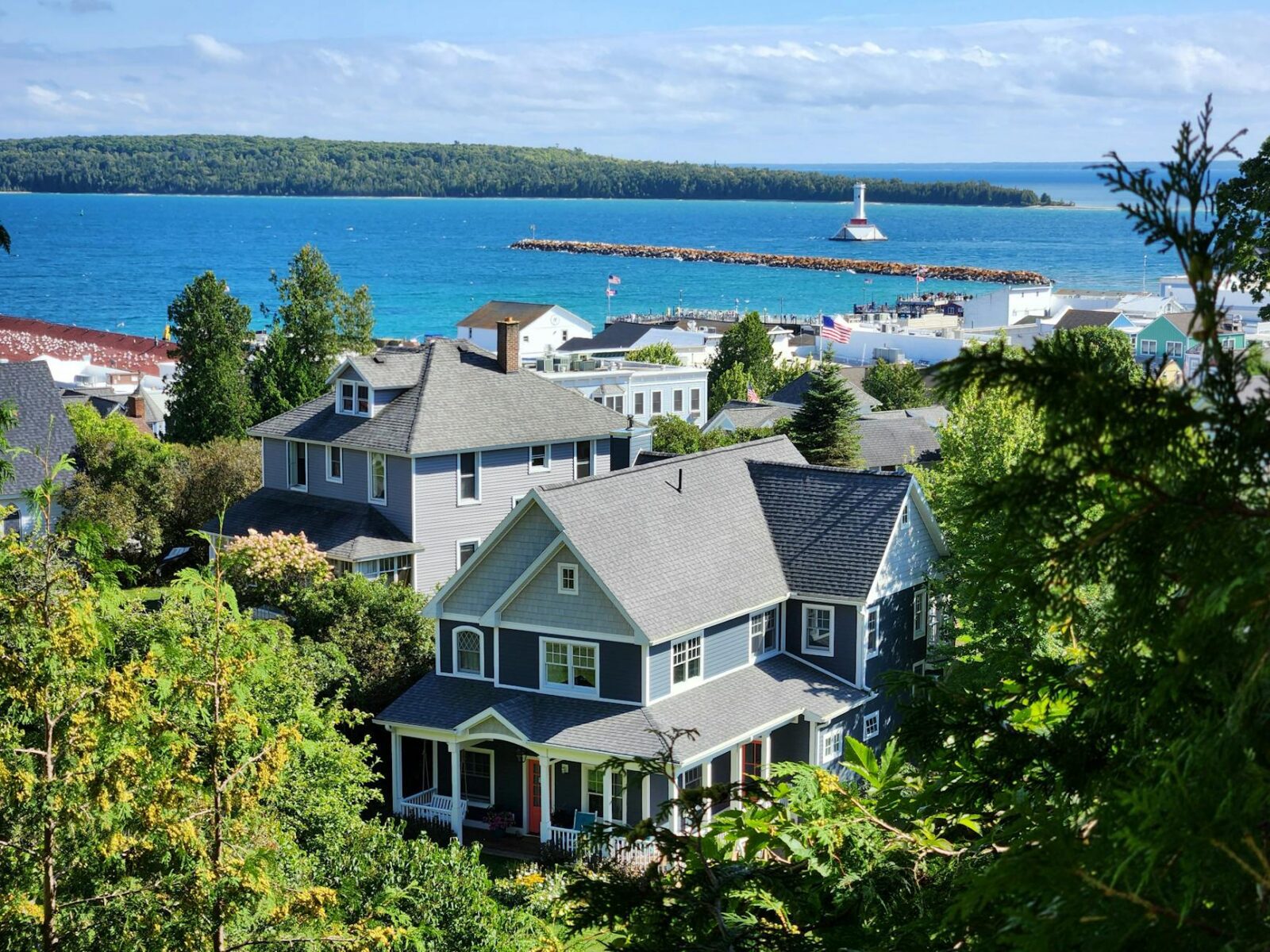 a view of houses and the ocean from a hill Moving to Michigan: Migration Trends and Top Destinations