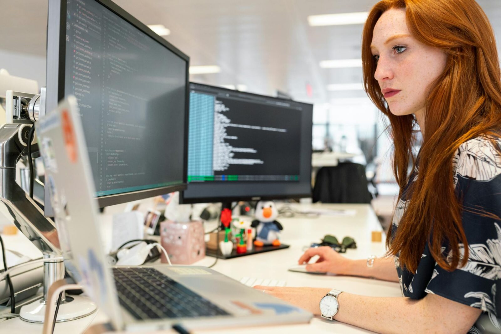 woman coding on computer Boost Office Efficiency: Uncover Hidden Workflow Bottlenecks