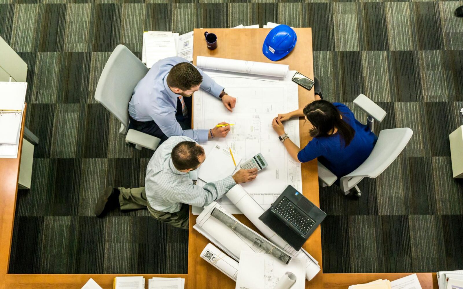 three people sitting beside table How to Move Offices Successfully: A Step-by-Step Business Relocation Guide