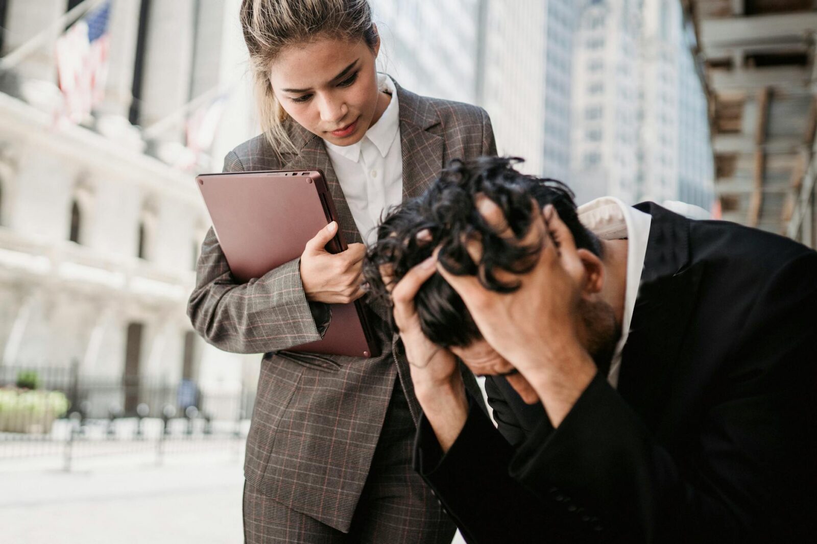 woman comforting the upset man https://modernfrontierswoman.com/the-role-of-workplace-safety-in-driving-business-success/