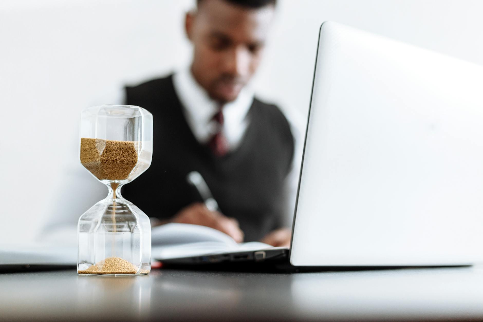 man in black suit jacket sitting beside table with macbook pro Planning a Career Change: Key Steps for a Smooth Transition