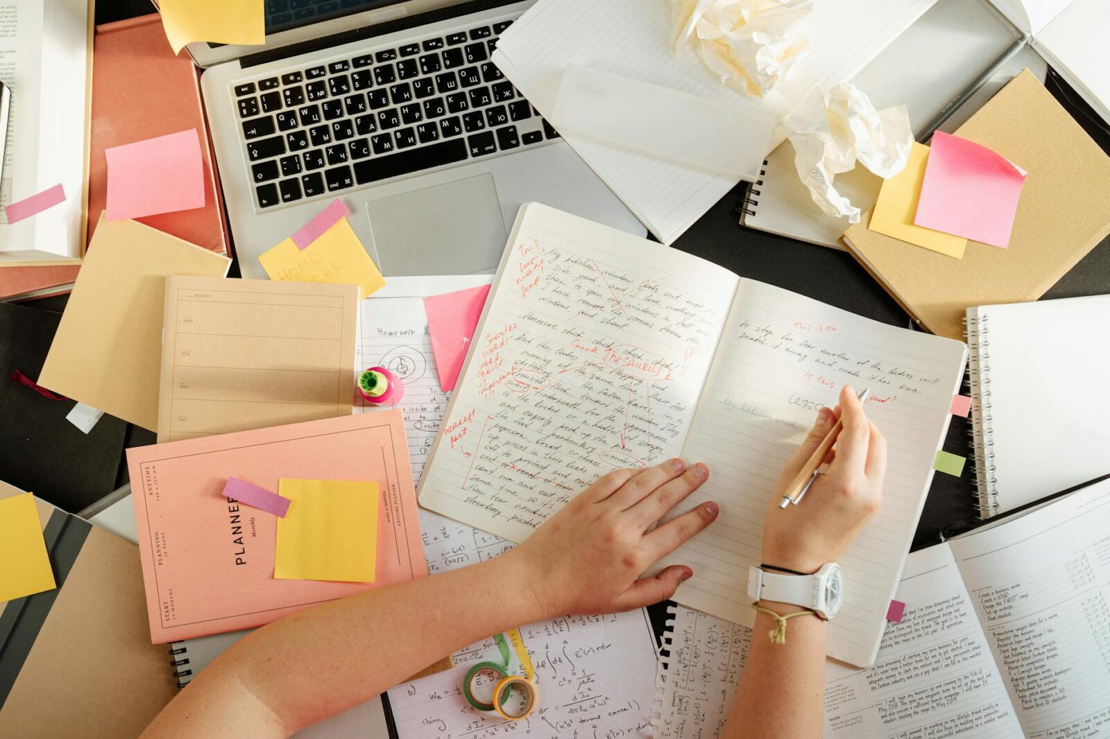 person writing on a notebook
