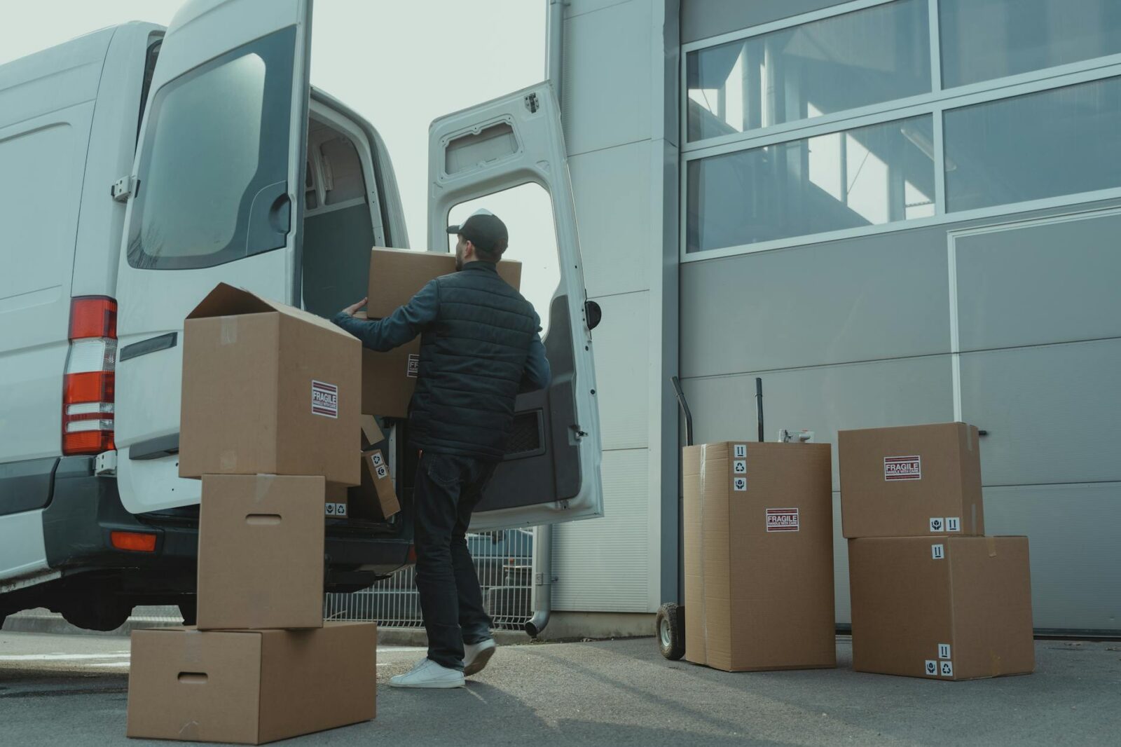 man in blue jacket and blue denim jeans sitting on brown cardboard box Why Packaging Design Is Part of Customer Service Levels (And How to Get It Right)