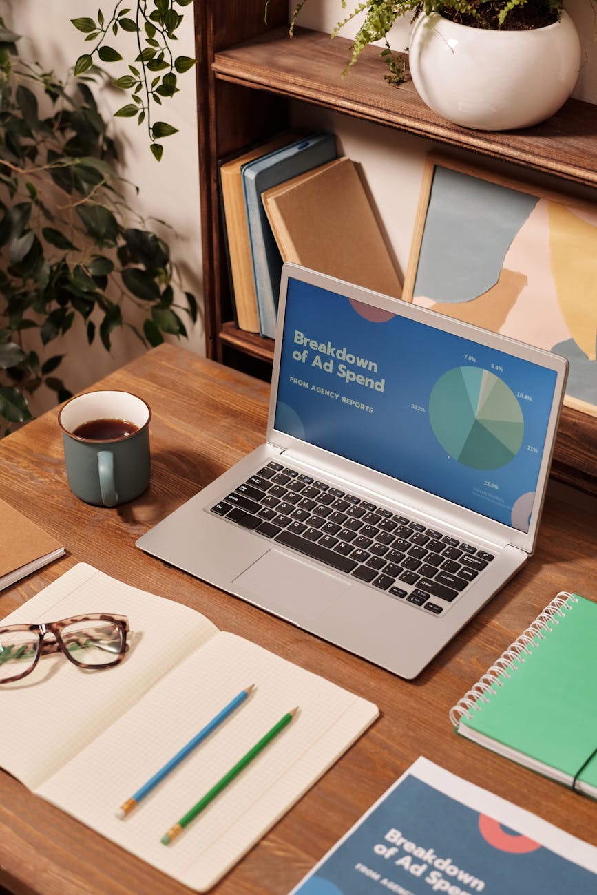 laptop on wooden desk 10 Proven Ways to Increase Your Business Visibility Online and Offline