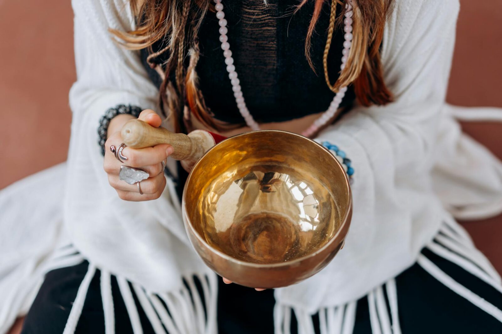 woman in white long sleeve shirt holding gold round bowl How To Develop Resilient Mental Health