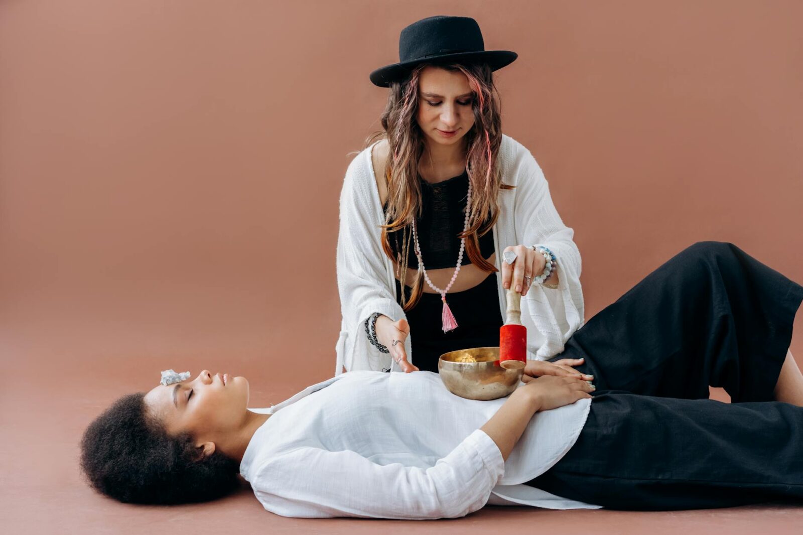 woman in white long sleeve shirt and black hat sitting on bed 4 Unusual Hobbies That Break Free From The Mold