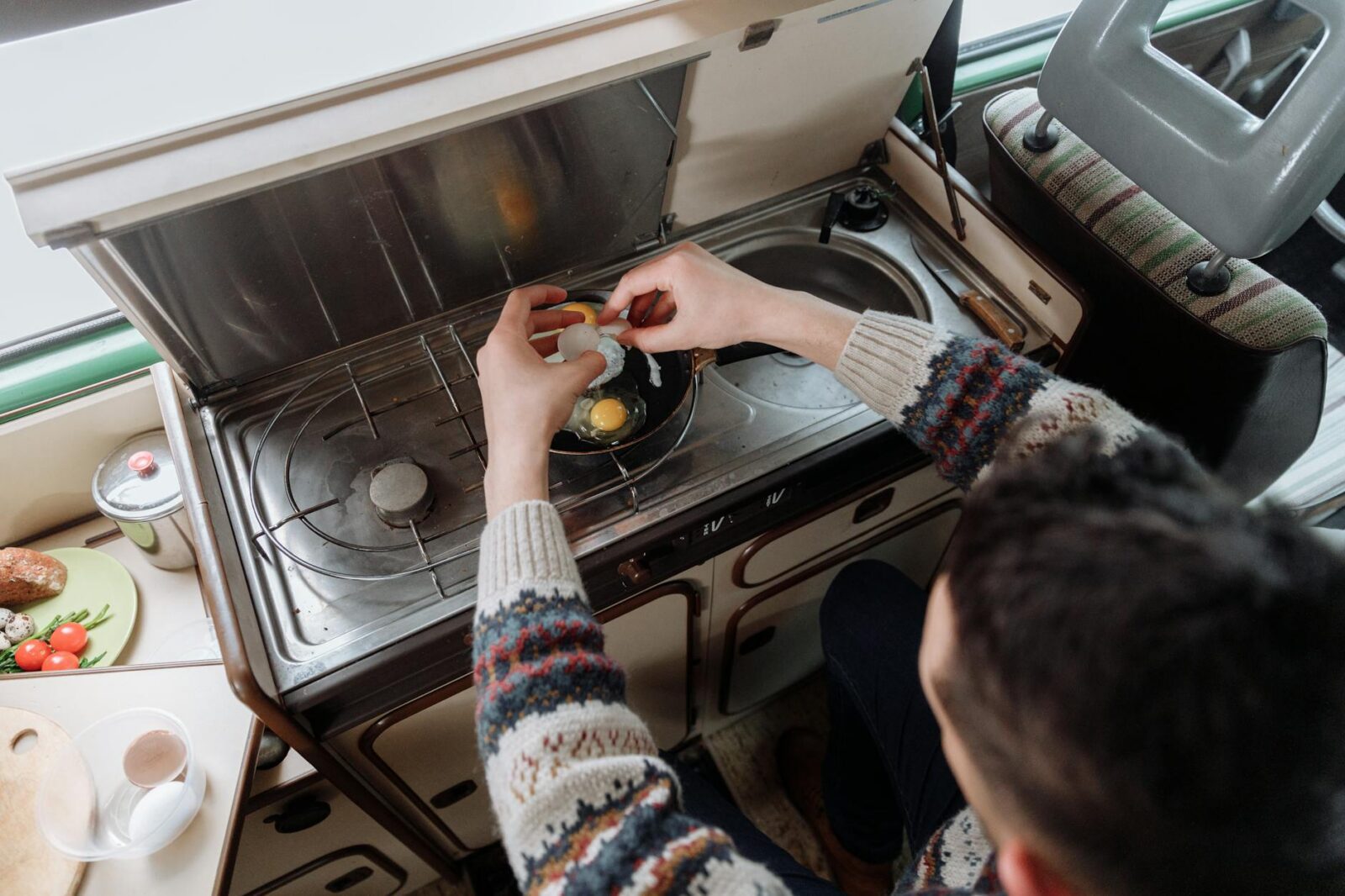 a person cooking eggs RV Trip Essentials: Plan an Epic Camping Adventure