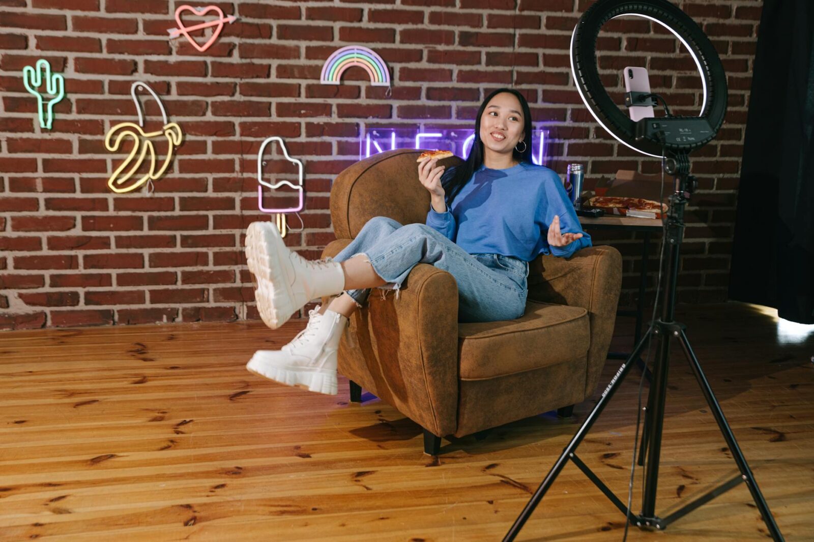 a woman recording herself with a smartphone while eating 5 Essential Strategies to Build Brand Visibility Long-Term