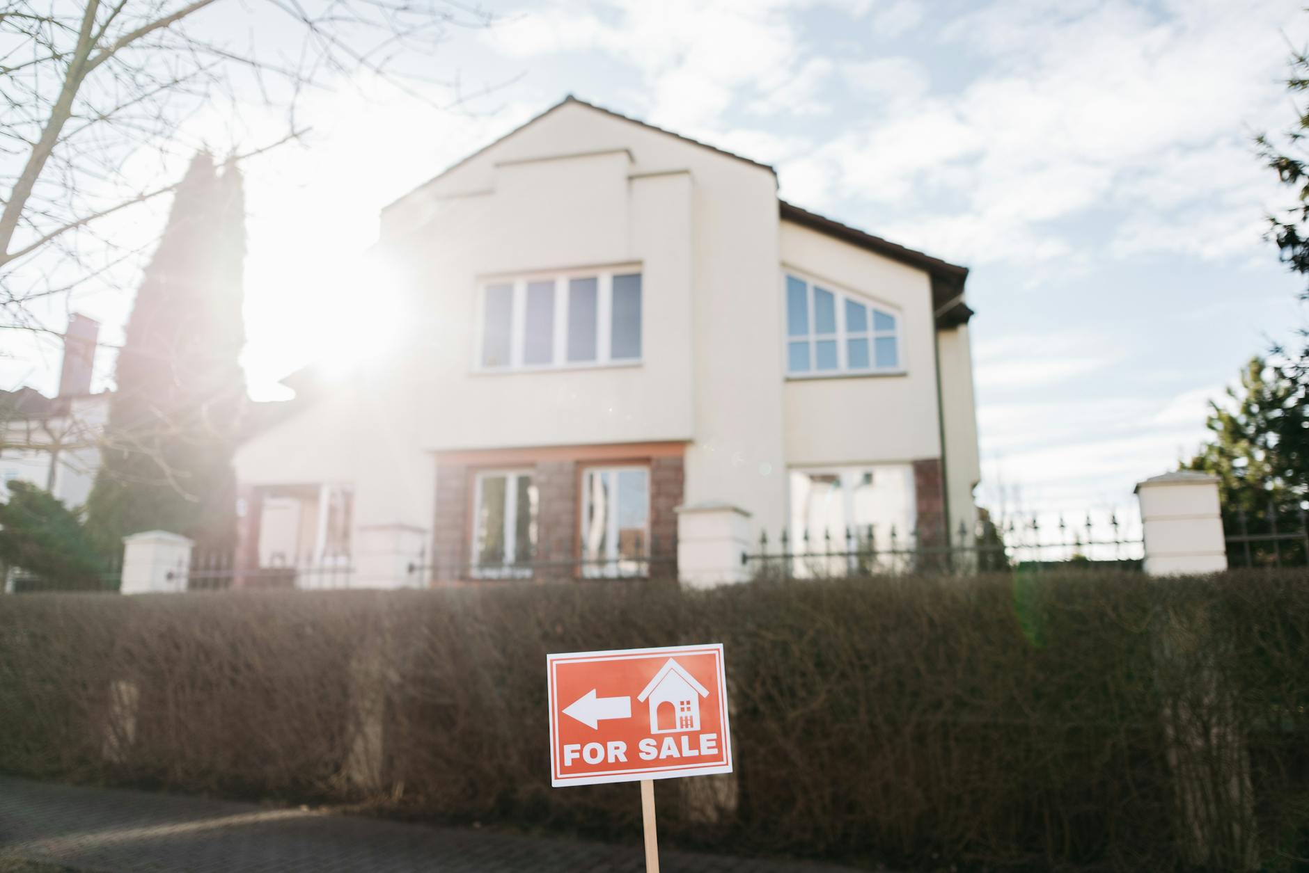 a signage in front of a house 4 Essential Tips for Buying Your First House