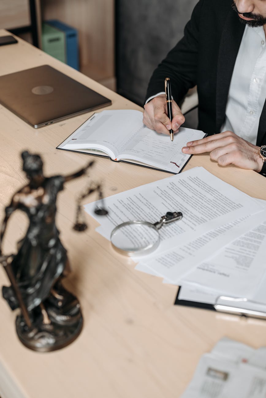 a man writing on a notebook Top Reasons to Pursue a Legal Career: Growth, Prestige, and Opportunity