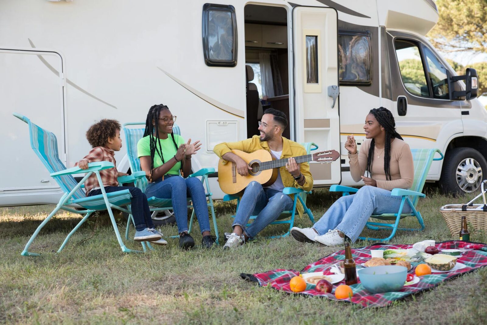 a family sitting beside the campervan 7 Fun Family Vacation Ideas Your Kids Will Love