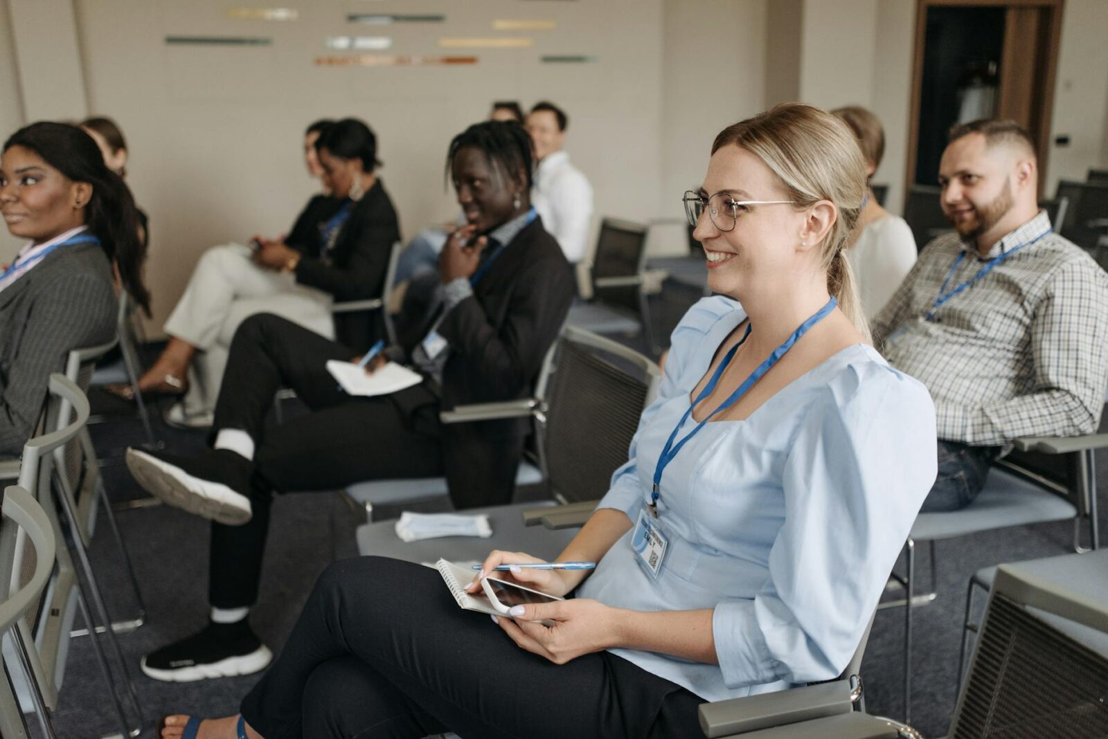 woman in blue long sleeve shirt sitting on gray chair smiling How to Plan a Successful Career Path