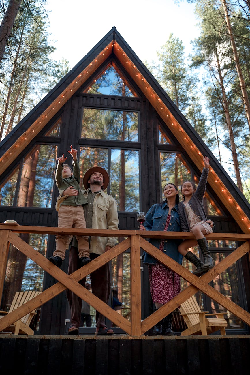 family standing on the balcony 7 Fun Family Vacation Ideas Your Kids Will Love