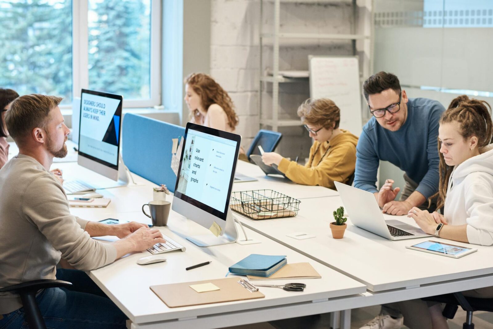people working in front of the computer Employee Online Policy: How to Create Clear Rules Your Team Will Actually Follow