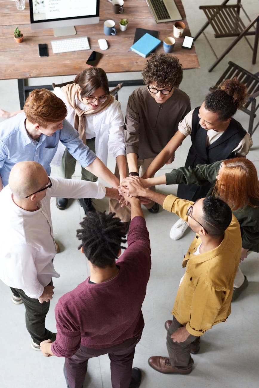 photo of people holding each other s hands Entrepreneurship 101: How To Make Running A Business Feel Less Stressful