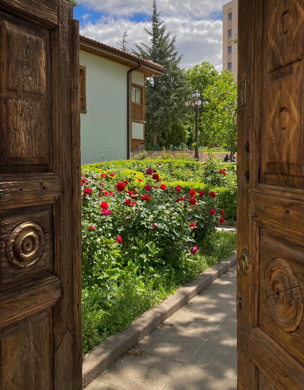 charming garden view through rustic wooden door The Ultimate List of Gardening Skills